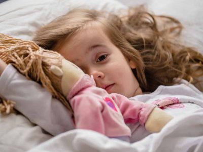 little-girl-falls-asleep-in-bed-with-soft-doll-white.jpg